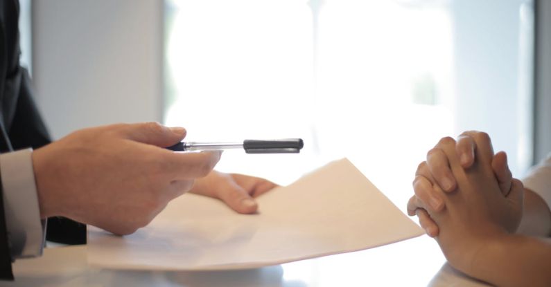 Investment Comparison - Crop businessman giving contract to woman to sign