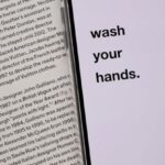 Personal Risk - Opened book with smartphone with warning message