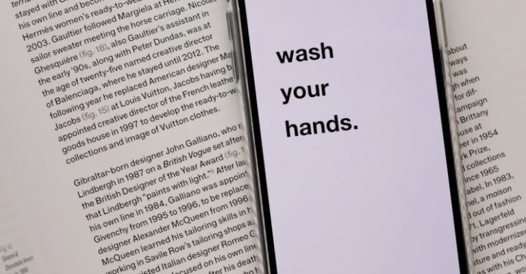 Personal Risk - Opened book with smartphone with warning message