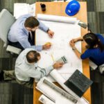 Liquidity Management - Three People Sitting Beside Table