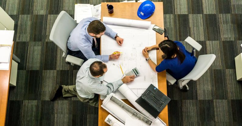 Liquidity Management - Three People Sitting Beside Table