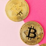 Blockchain Technology - Gold Round Coins on Pink Surface