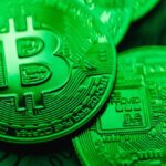 Blockchain Technology - Closeup of Bit Coins in a Green Light