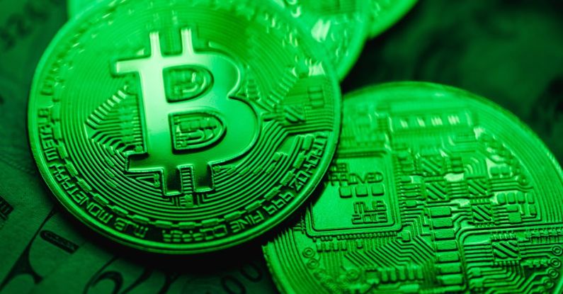 Blockchain Technology - Closeup of Bit Coins in a Green Light