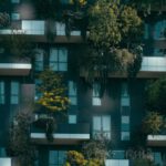 ICO Investment - Modern residential building facade decorated with green plants