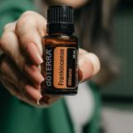 Company Valuation - A woman holding up a bottle of essential oil
