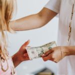 Kids Finance - Woman Giving 10 Dollars to a Girl