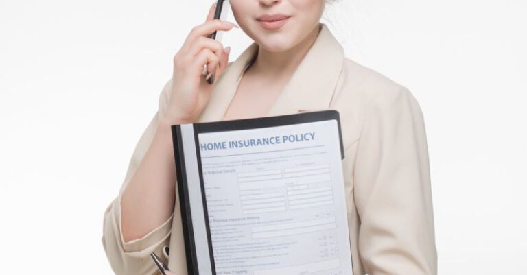Insurance Policy - A Woman in Beige Blazer Holding a Document while Having a Phone Call