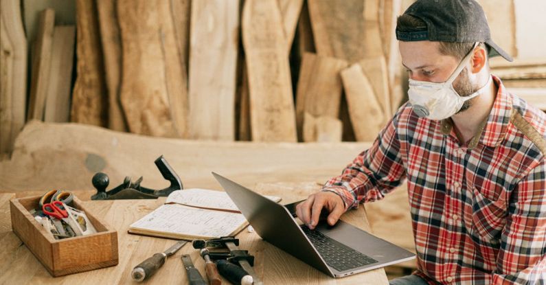 Remote Work - Man Using a Laptop at a Wood Workshop