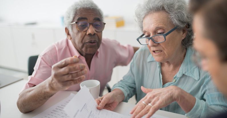 Robo-advisor - Two Seniors Looking at Papers