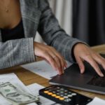 Biotechnology Investment - A Woman in Plaid Blazer Using Her Laptop