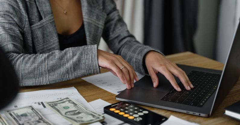 Biotechnology Investment - A Woman in Plaid Blazer Using Her Laptop