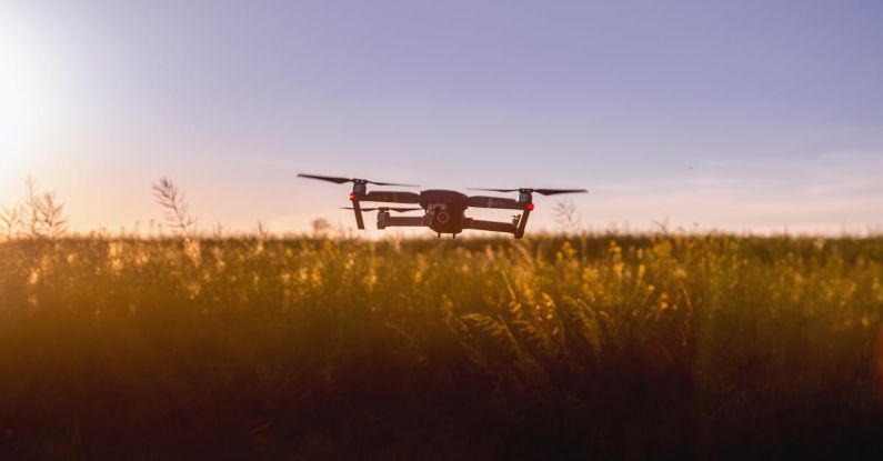 Agriculture Technology - Black Quadcopter Drone on Green Grass Field