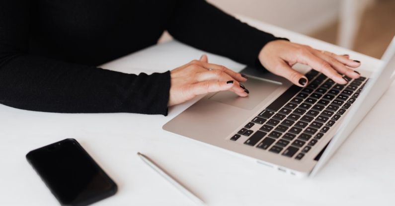 Annuities Plan - Crop faceless woman working on netbook in office