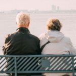 Mistakes Retirement - Elderly Couple Sitting on Bench in Seaside