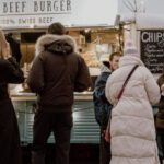 Volatile Market - People by the Food Truck on a Street