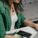 5G Technology - A woman sitting at a desk with a laptop and a bottle of essential oils