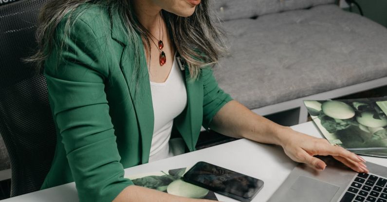 5G Technology - A woman sitting at a desk with a laptop and a bottle of essential oils