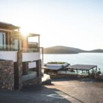 Luxury Real Estate - Sun Piercing of Brown Concrete House Near Sea