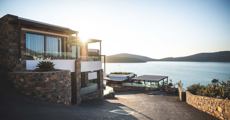 Luxury Real Estate - Sun Piercing of Brown Concrete House Near Sea