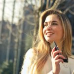 Real Estate Tech - Woman Wearing White Top Holding Smartphone and Tablet