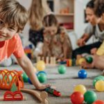 Asset Classes - Boy in Orange Shirt Playing on the Floor