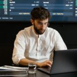 Crypto Diversification - Focused Professional Man using Laptop