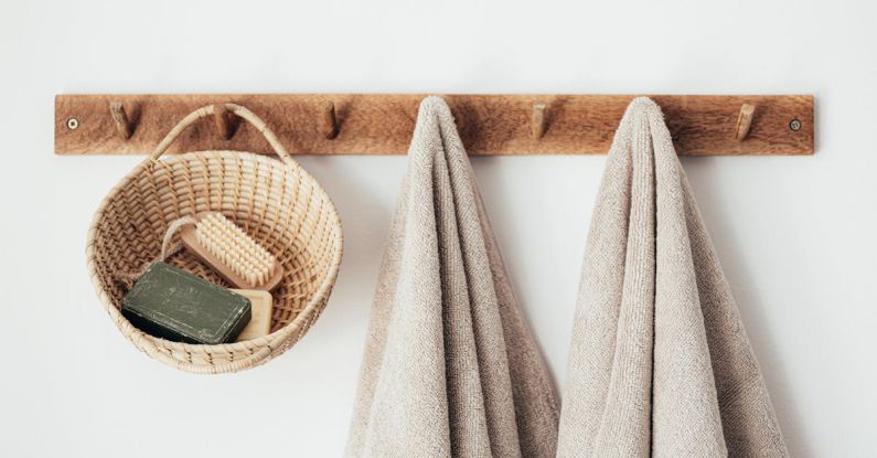 Sustainable Challenges - Wooden hanger with towels and basket with bathroom products