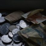 Retirement Savings - A tray full of coins and money