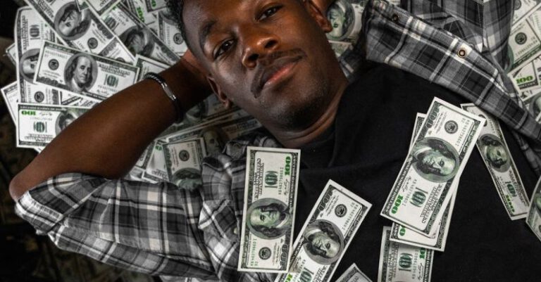 Money Mistake - A man laying on top of a pile of money